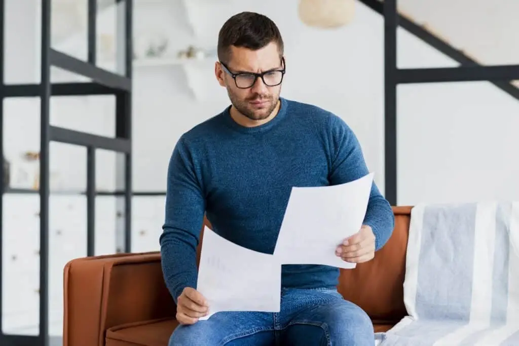 Business owner reviewing energy contract documents at home
